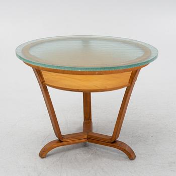 A Swedish Modern coffee table with a glass top. 1940's.