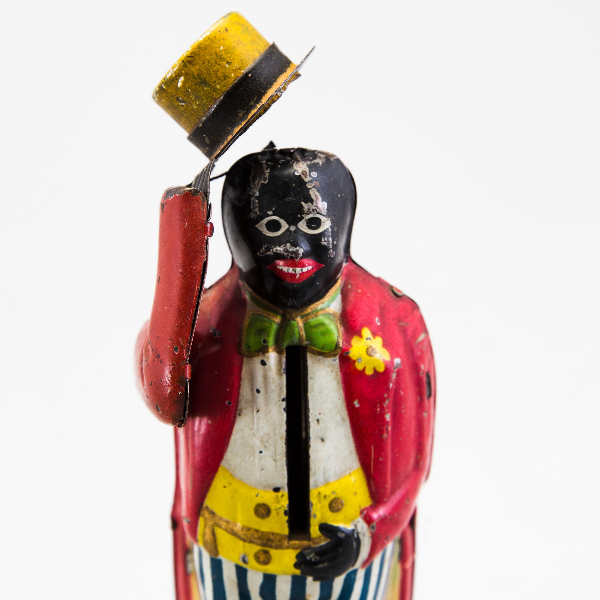 A tinplate coin bank by J. Levy & Co, England, probably of German manufacture, ca 1909.
