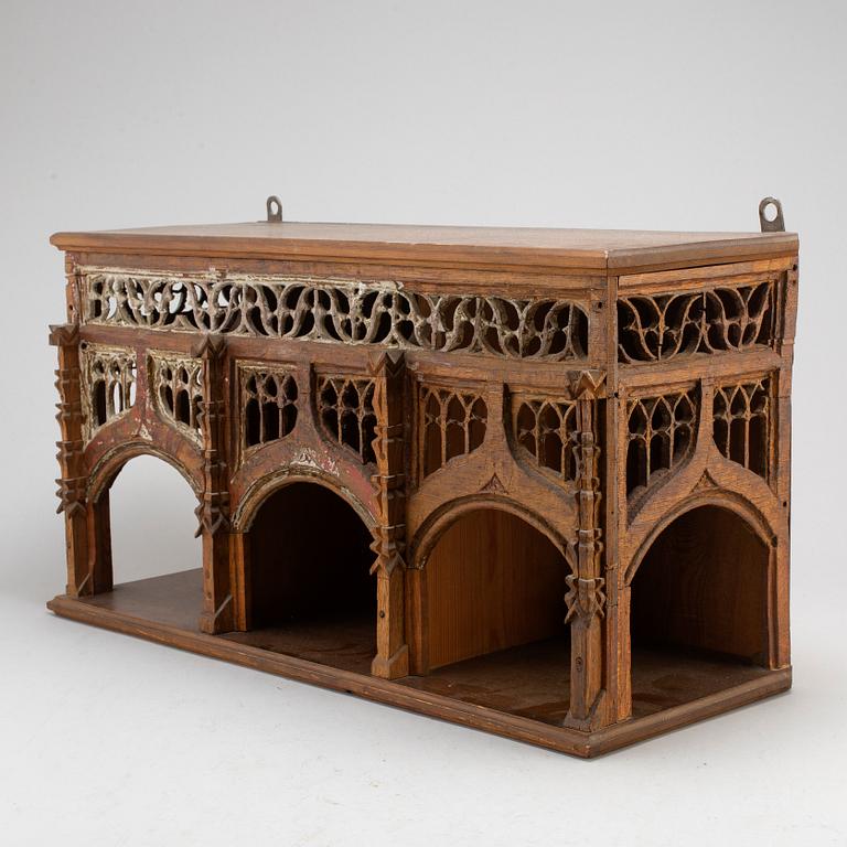 A Gothic style wall shelf, circa 1900.