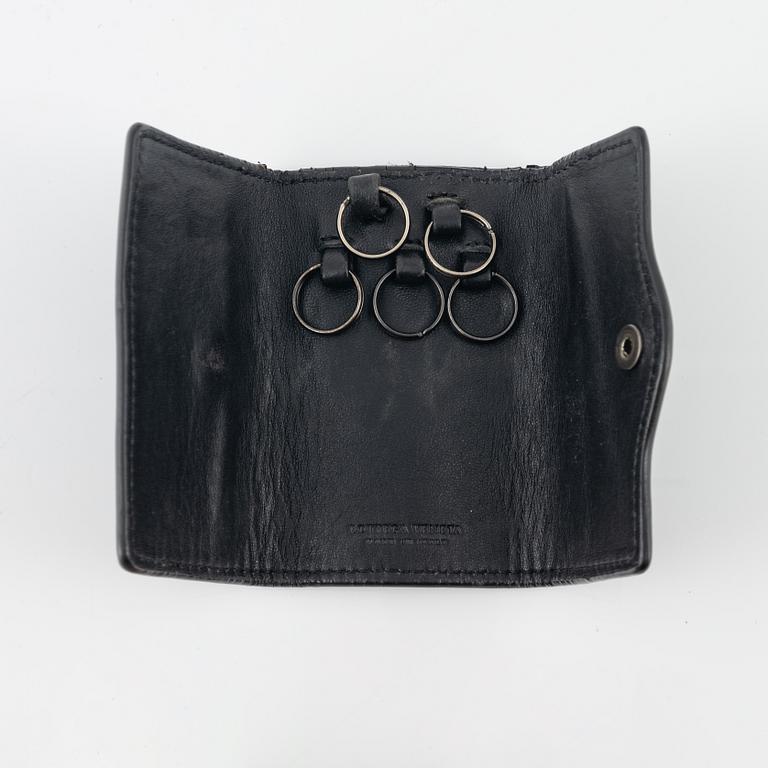 Bottega veneta, a black leather key case and wallet.