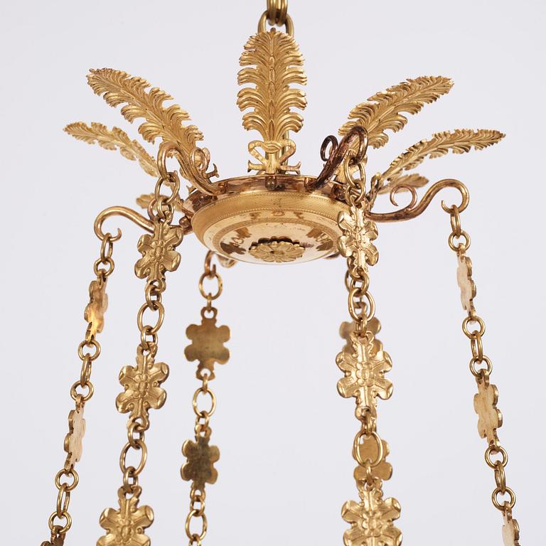 An Empire cut glass and gilded bronze six-light hanging lamp in the manner of Alexandre Guérin.