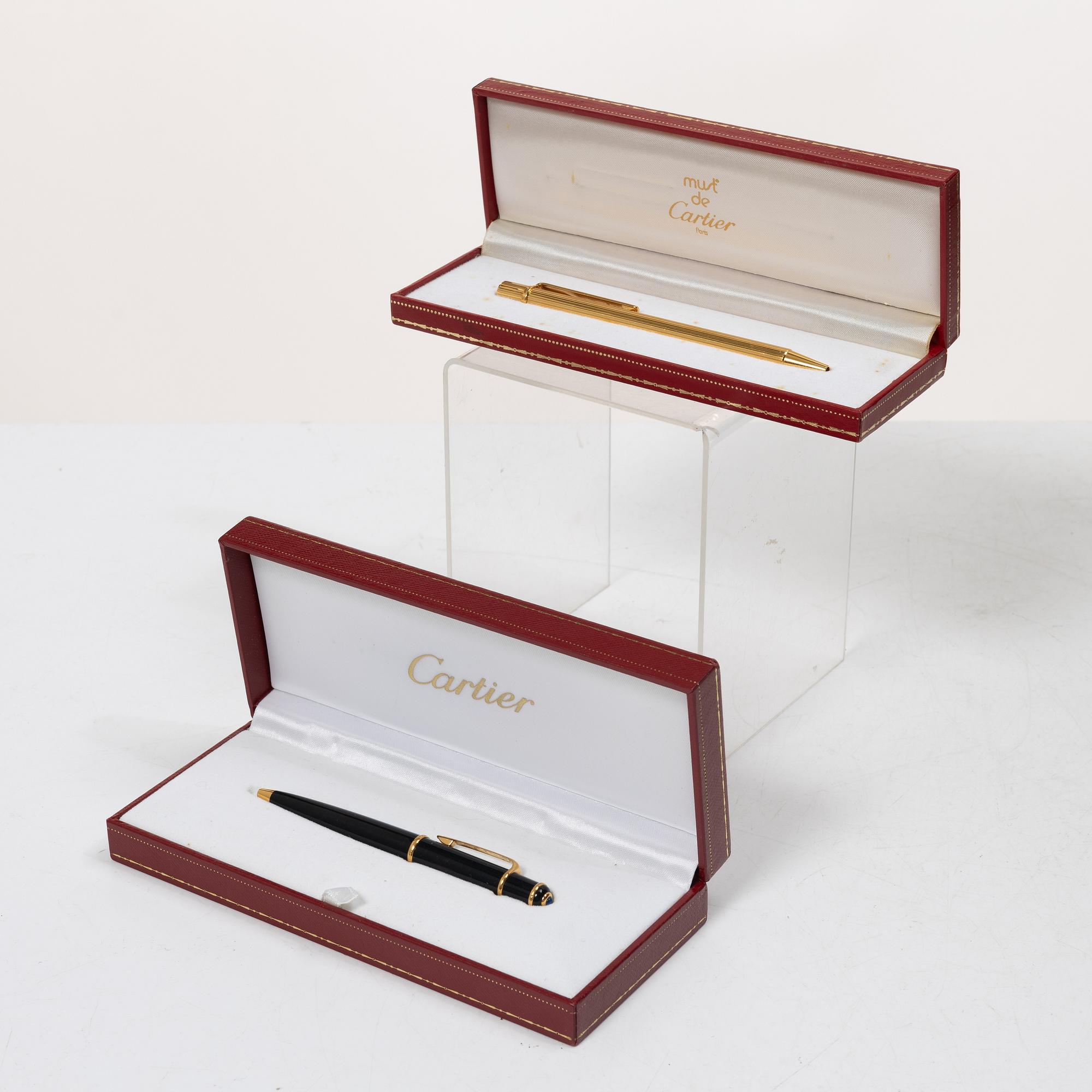 Cartier, Two ballpoint pens, 'must de Cartier' and 'Diabolo de Cartier'.