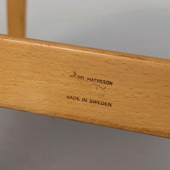 an "Eva" armchair by BRUNO MATHSSON 1963.