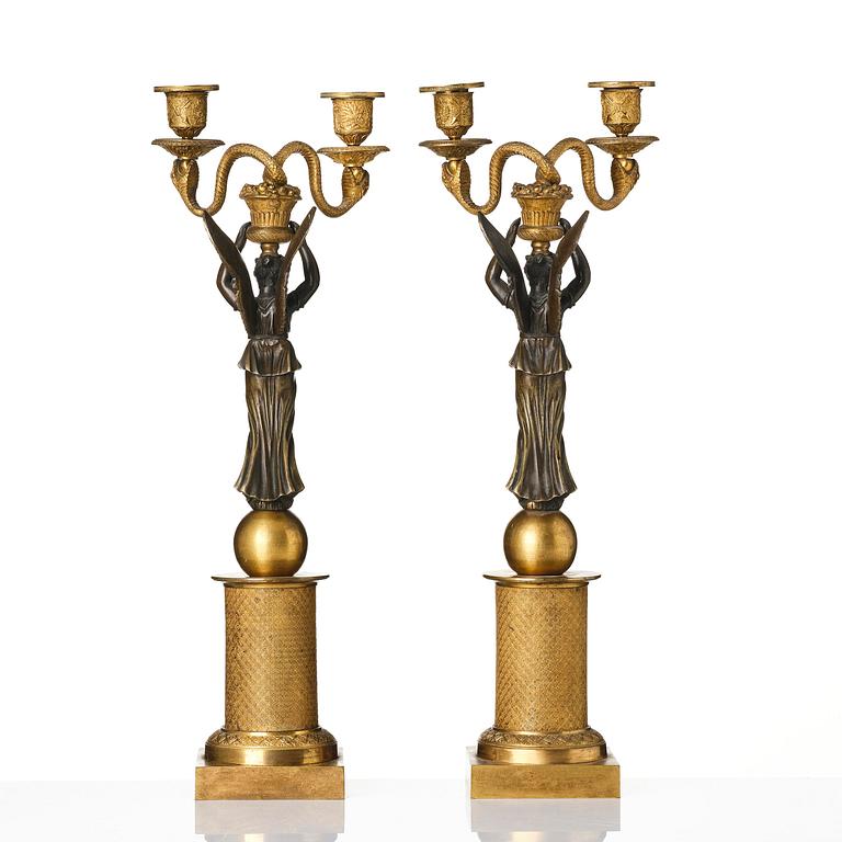 A pair of gilt and patinated bronze Empire-style two branch candelabra, later part 18th century.
