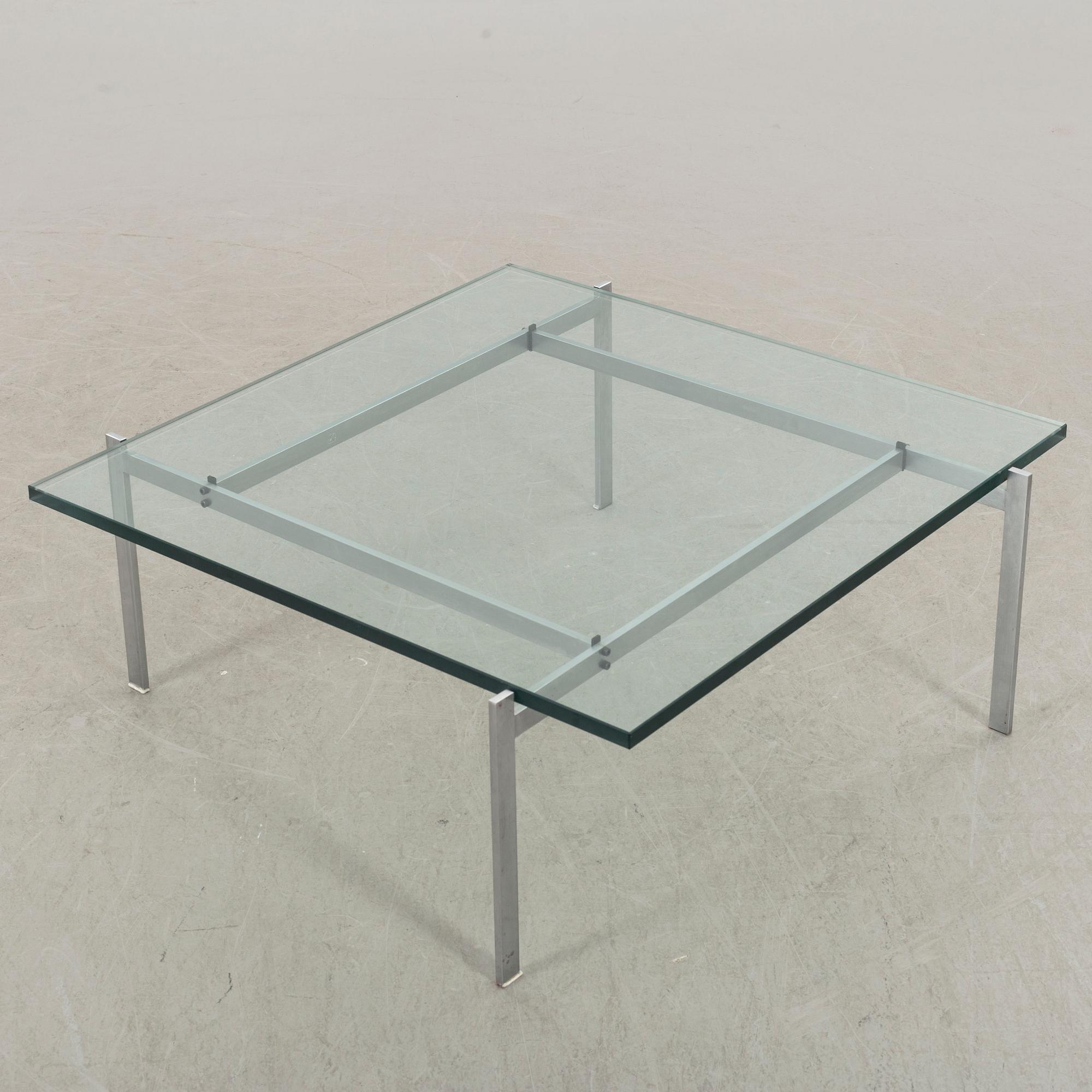 A Poul Kjaerholm PK61 glass table by Fritz Hansen.