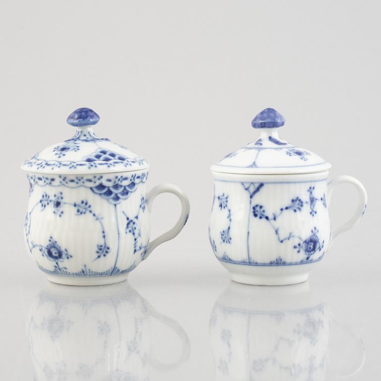 Two 'Blue Fluted' / 'Musselmalet rifflet' porcelain cream cups with covers, Royal Copenhagen, 19th century and 1964.