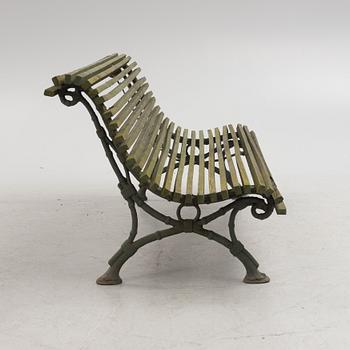 A cast iron-frame garden sofa, circa 1900.