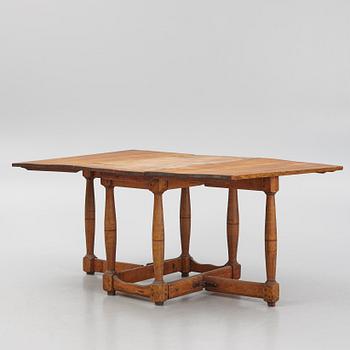 A drop-leaf table, 18th Century.