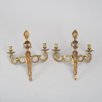 A pair of brass wall lights, Louis XVI-style, 20th century.