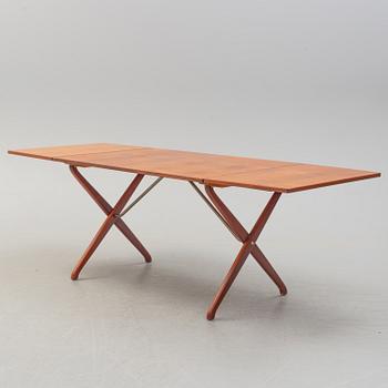 A teak veneer and stained beech dining table, mid 20th Century.