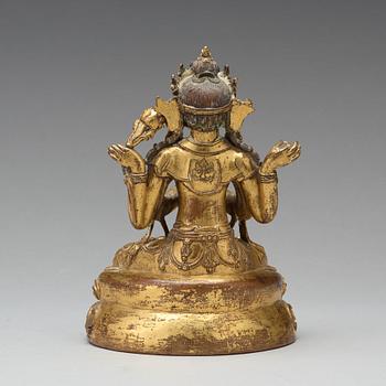 A gilt copper alloy four armed Sadaksari Avalokiteshvara, Tibet/Nepal, 15th Century or older.