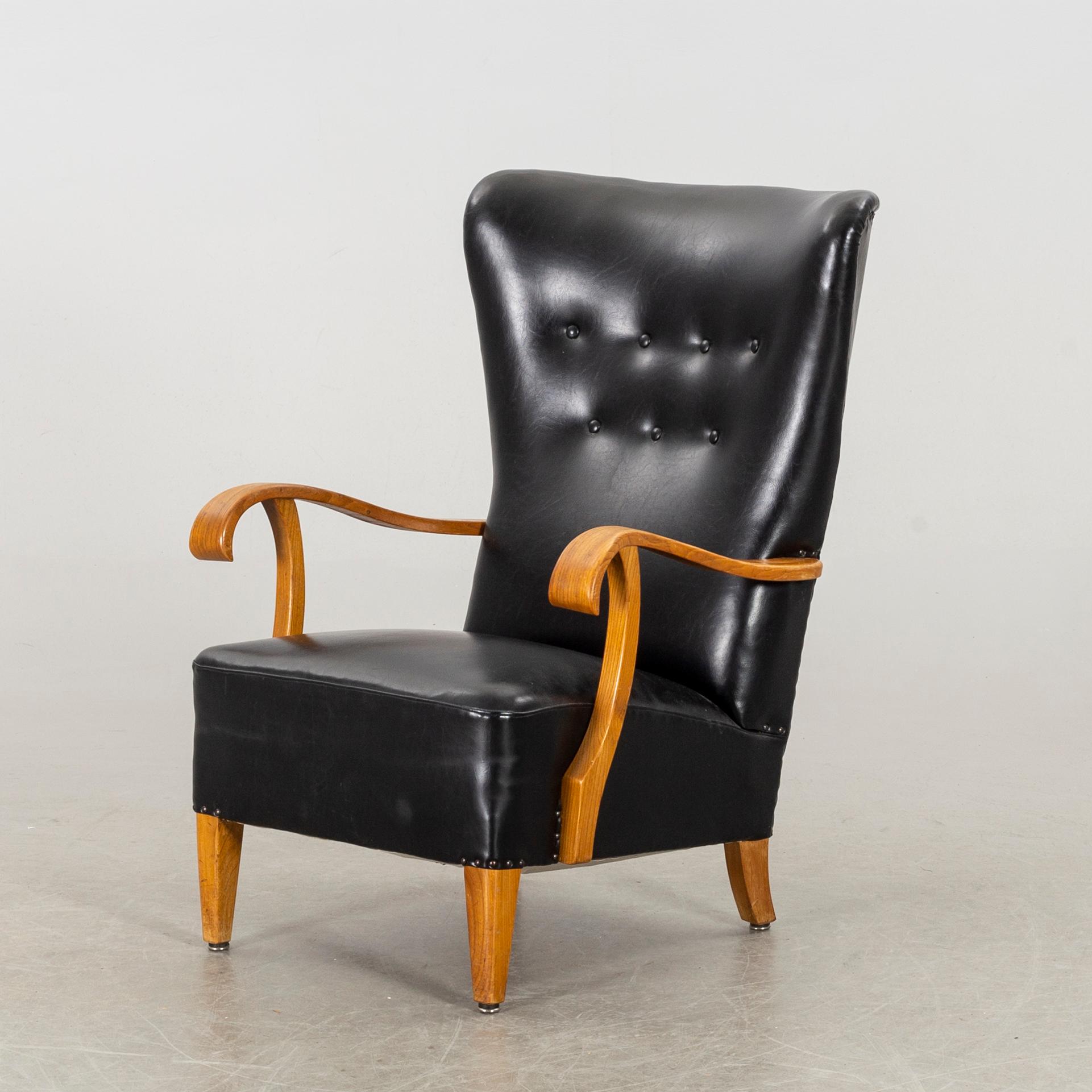 A 1940's - 50's easy chair in black leather, Scandinavian.