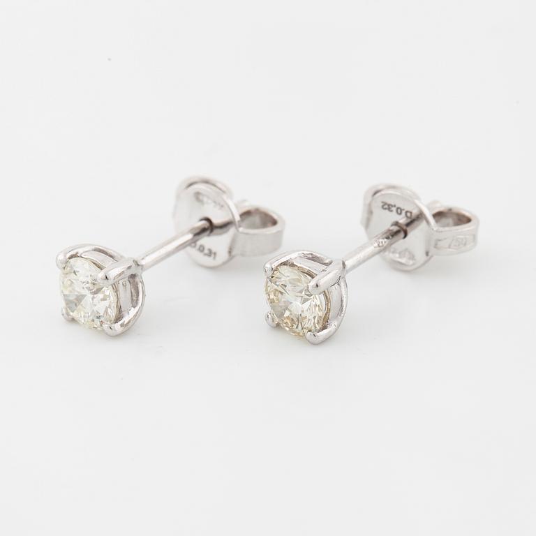 A pair of brilliant cut diamond earrings.