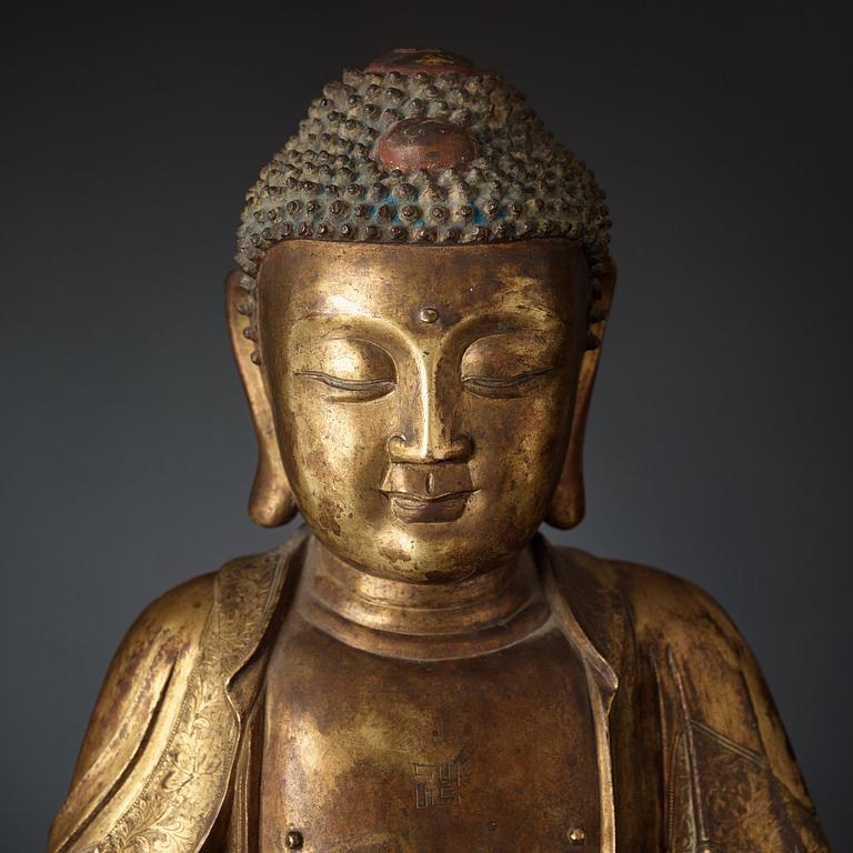 A large gilt bronze figure of Buddha, Ming dynasty (1368-1644).