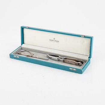 A sterling silver grape scissor and a nutcracker, design Johan Rohde, Georg Jensen, Copenhagen, post 1945.