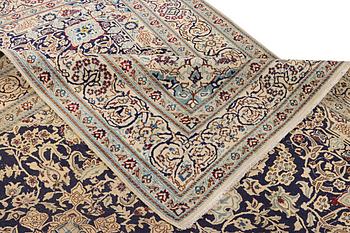 A Nain carpet, part silk, c. 338 x 244 cm.