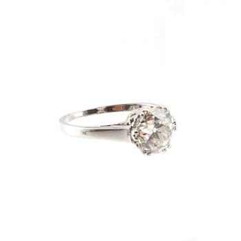 An 18K white gold solitaire ring set with a round old-cut diamond.