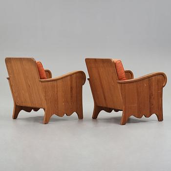 Axel Einar Hjorth, attributed, a pair of stained pine "Lovö" easy chairs, Nordiska Kompaniet, Sweden 1930's.