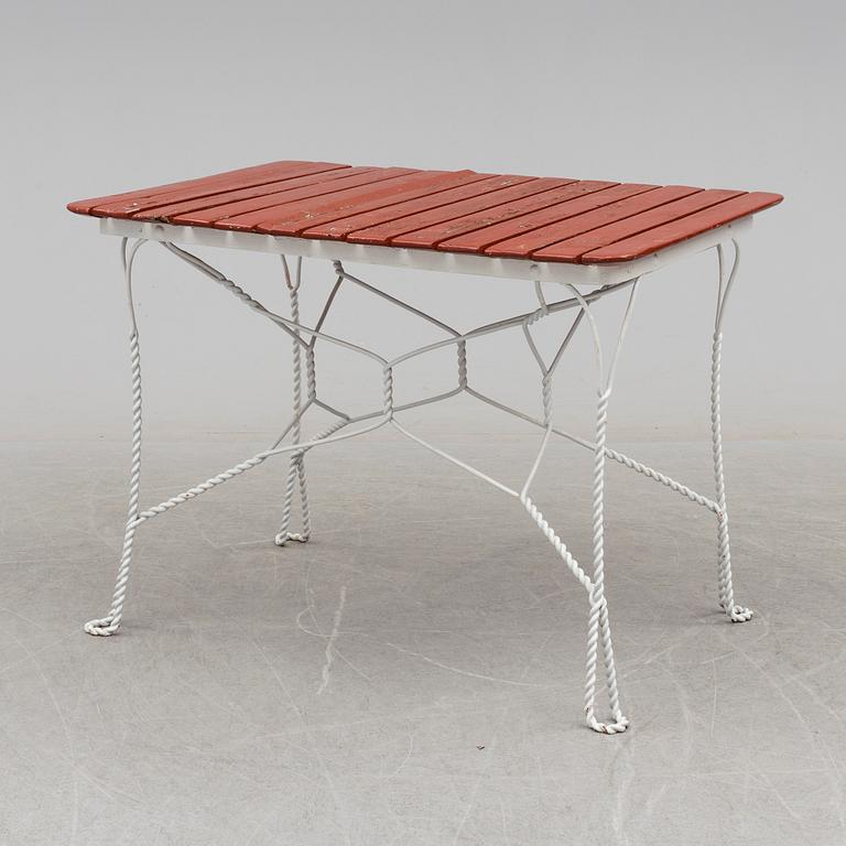 A garden table and four chairs, first half 20th century.