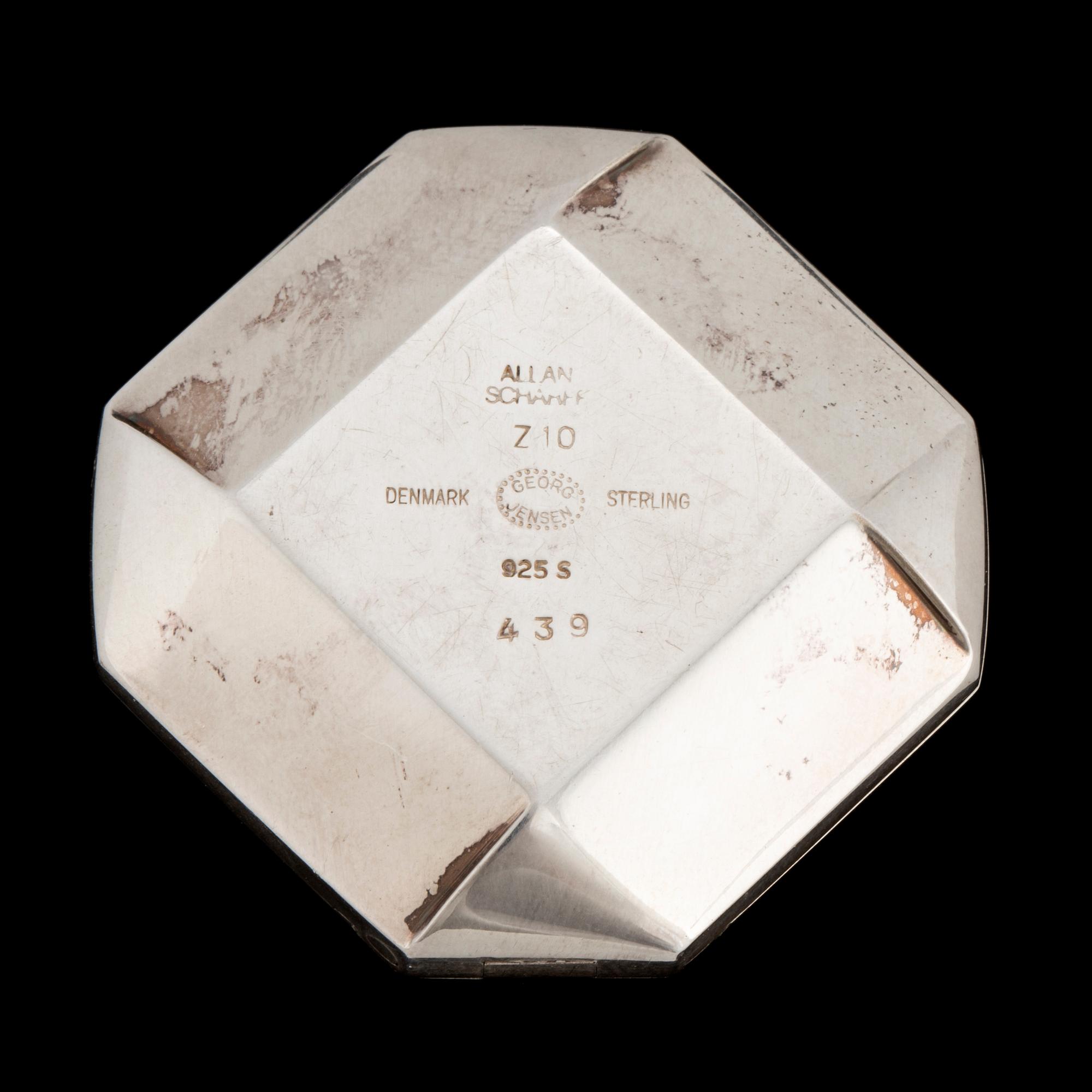 A silver Golf point, a box and two ball markers by Georg Jensen.