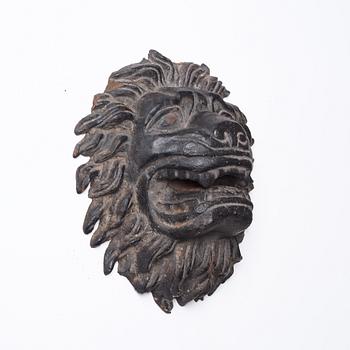 Anna Petrus, a cast iron mascaron in the shape of a lion's head.