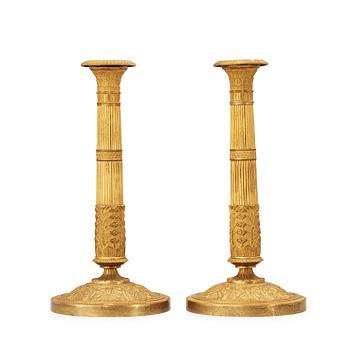 518. A pair of French Empire early 19th century candlesticks.
