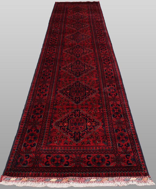 A Afghan runner carpet, 388 x 79 cm.