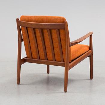 A 1960s teak Grete Jalk armchair from Glostrup, Denmark.