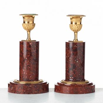 Two matched of 19th century Empire-style porphyry  candlesticks.