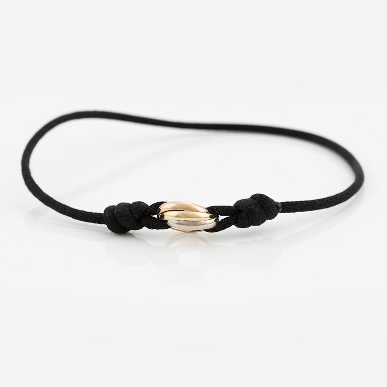 A Cartier "Trinity" bracelet, 18K three colour gold and textile.