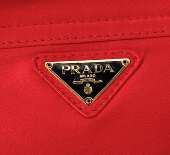 A red silk shoulder bag by Prada.