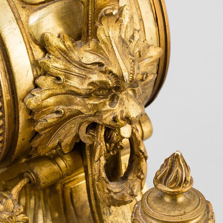 A table CLOCK and a pair of candelabra, second part of 19th century.