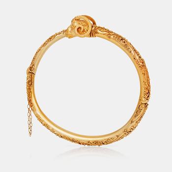 538. An etruscan revival rams head gold bangle.