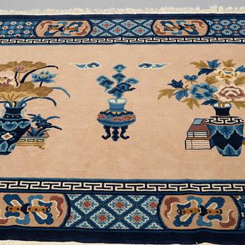 A RUG, old China, ca 137,5 x 193,5 cm (as well as 1 cm flat weave at the ends), "antique finish".