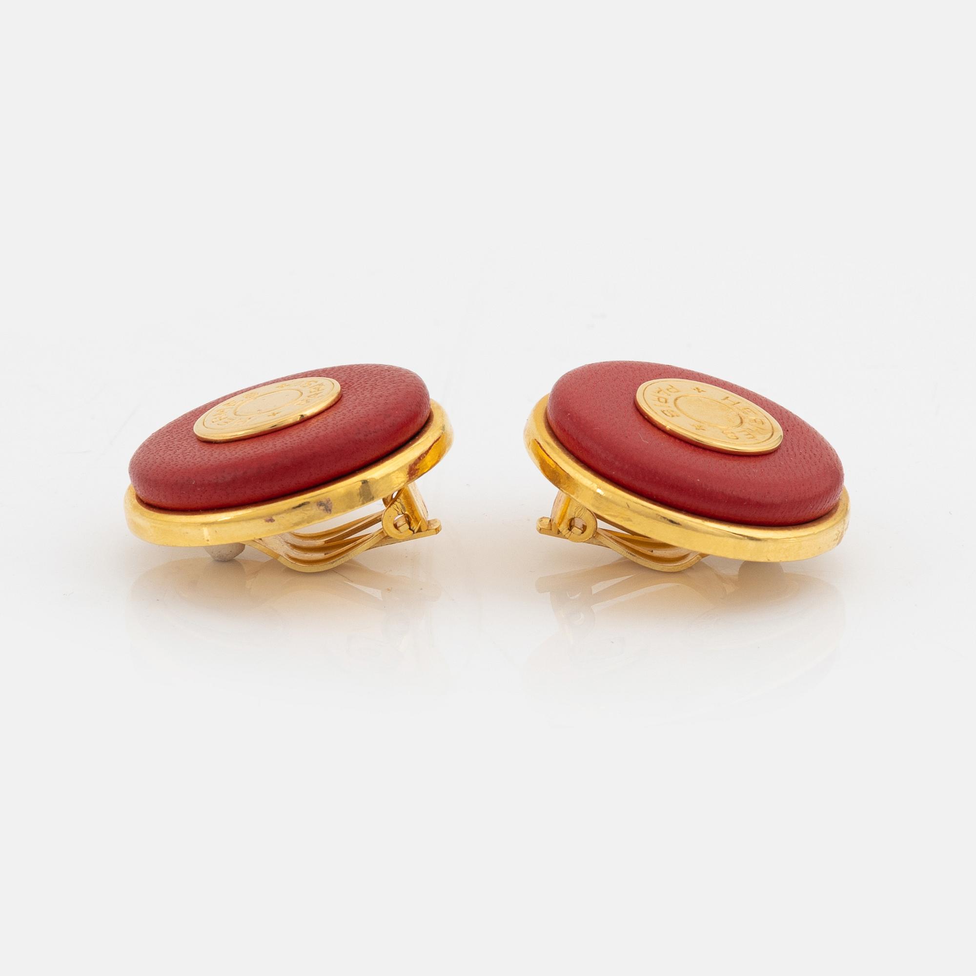 Hermès, a pair of gold tone metal and leather clip-on earrings.
