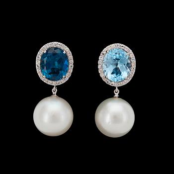 938. A pair of cultured South sea pearl, 14,5 mm, blue topaz and white sapphire earrings.