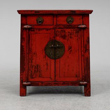 A red lacqured Chinese cabinet, 20th Century.