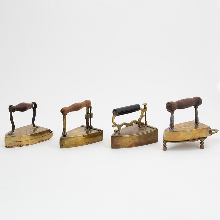 A set of four Swedish brass irons, 18th/19th Century.