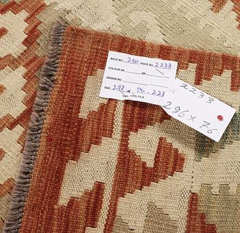 An Afghan kilim runner, c. 296 x 78 cm.
