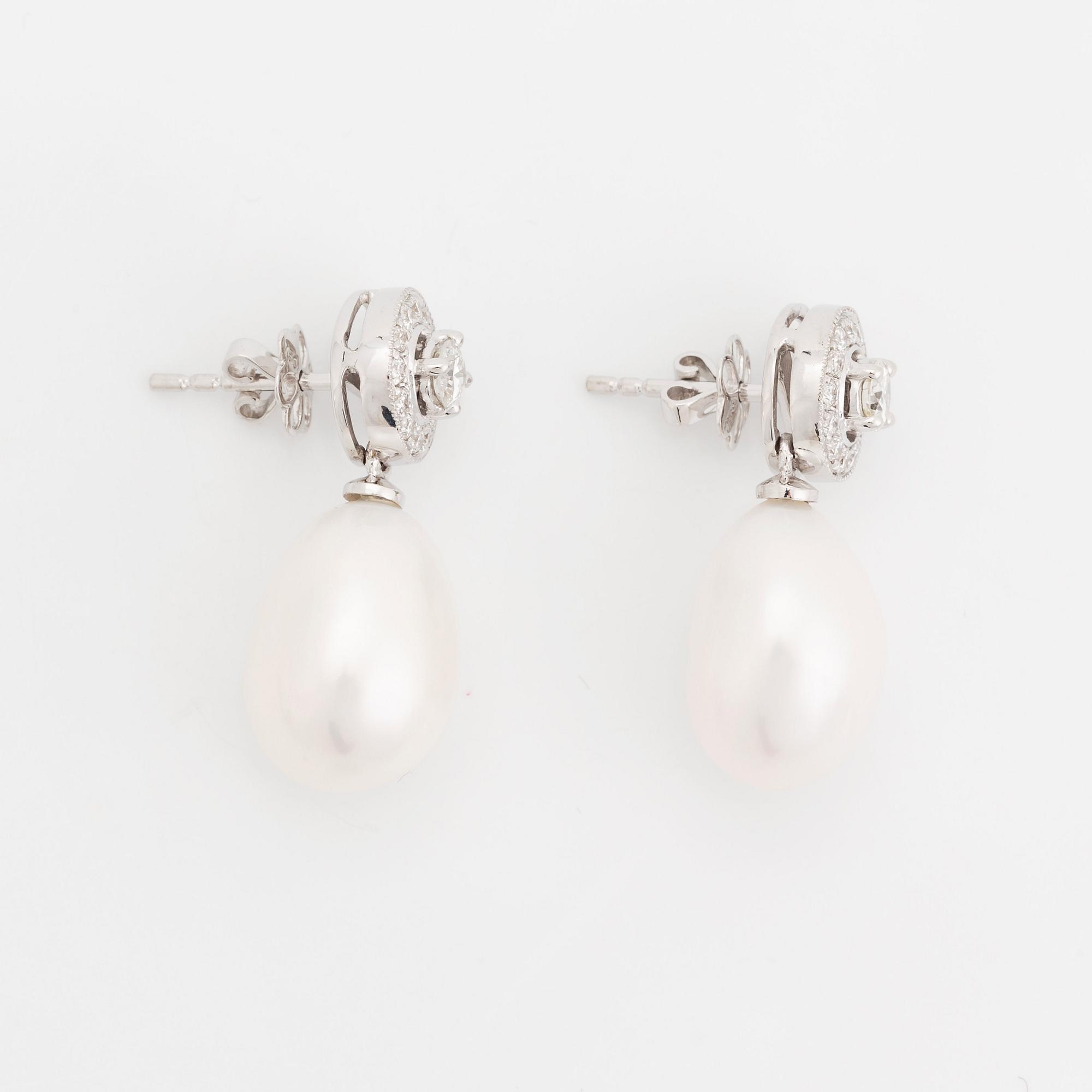 A pair of 18K white gold and cultured pearls earrings set with round brilliant-cut diamonds.