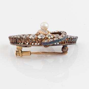 A 14K gold brooch set with old-cut diamonds and a pearl.
