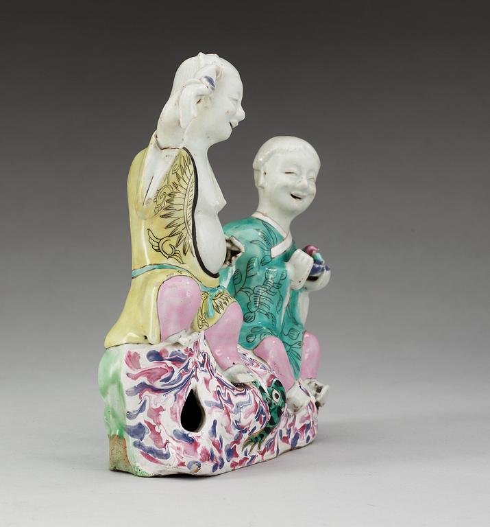 A famille rose figure of two boys, Qing dynasty, ca 1800.