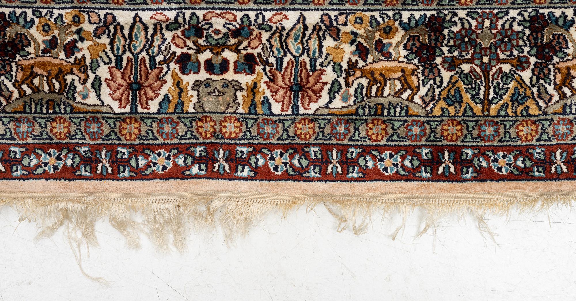 An oriental silk carpet, c. 305 x 205 cm.