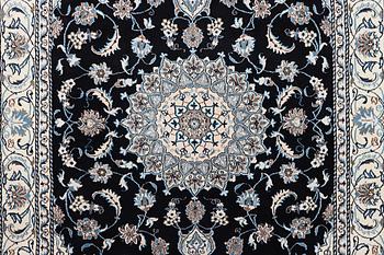 A Nain carpet, part silk, c. 286 x 206 cm.