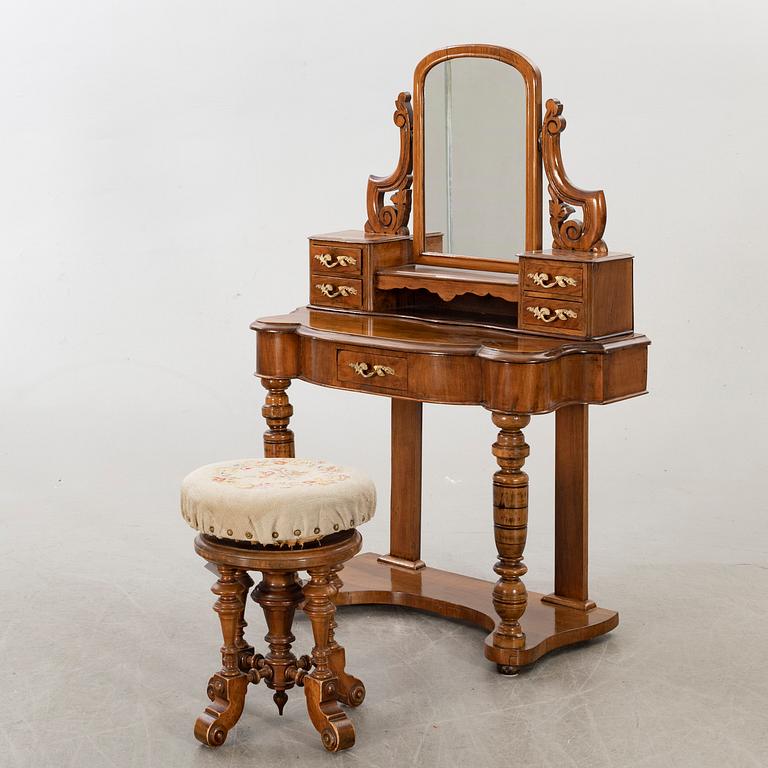A second half of the 19th century table with mirror and a stool.