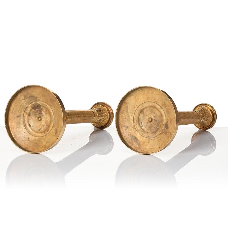 A pair of French Empire ormolu candlesticks, early 19th century.
