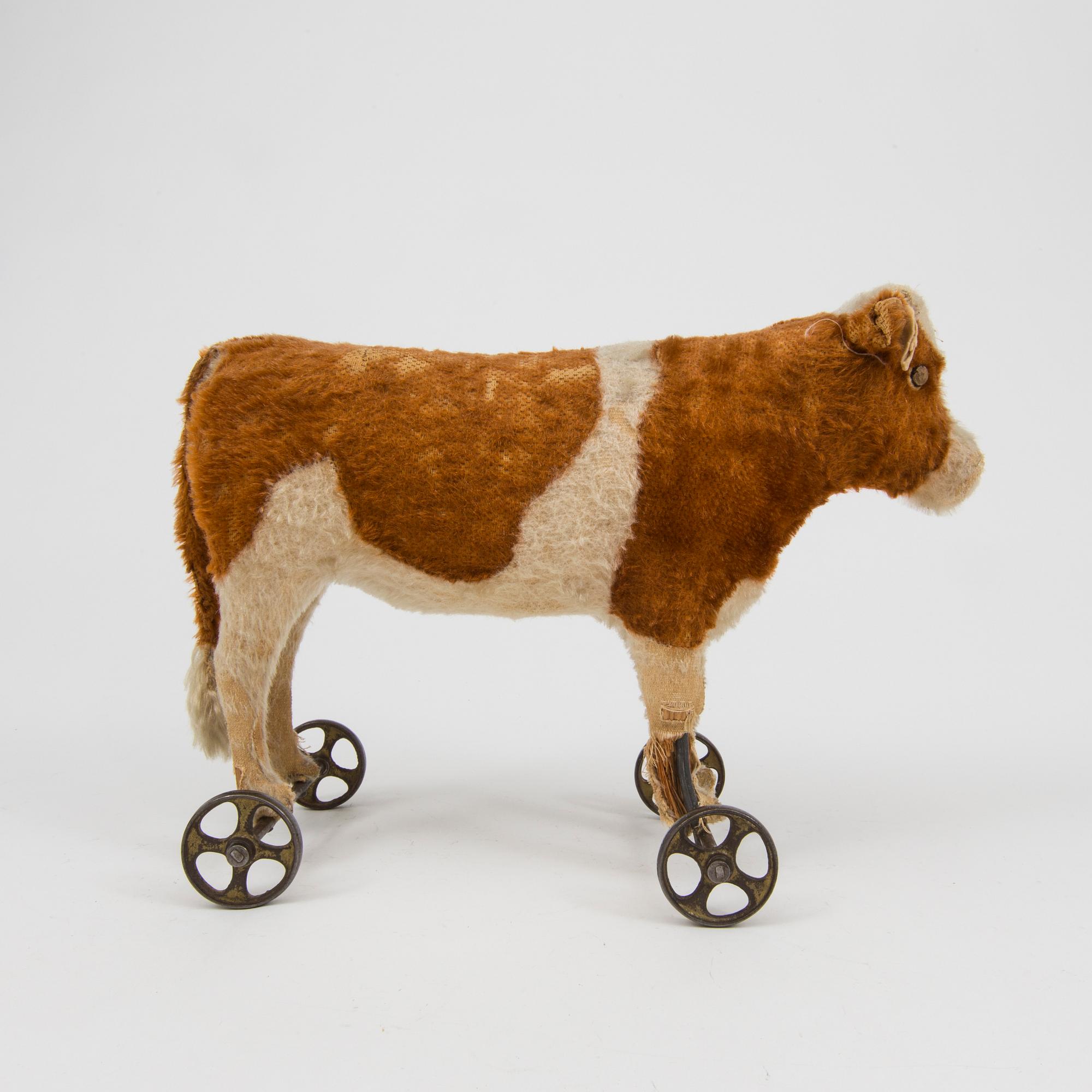 A Steiff cow and a Schuco "Tricky", Germany, 1910 and 1930/40s.