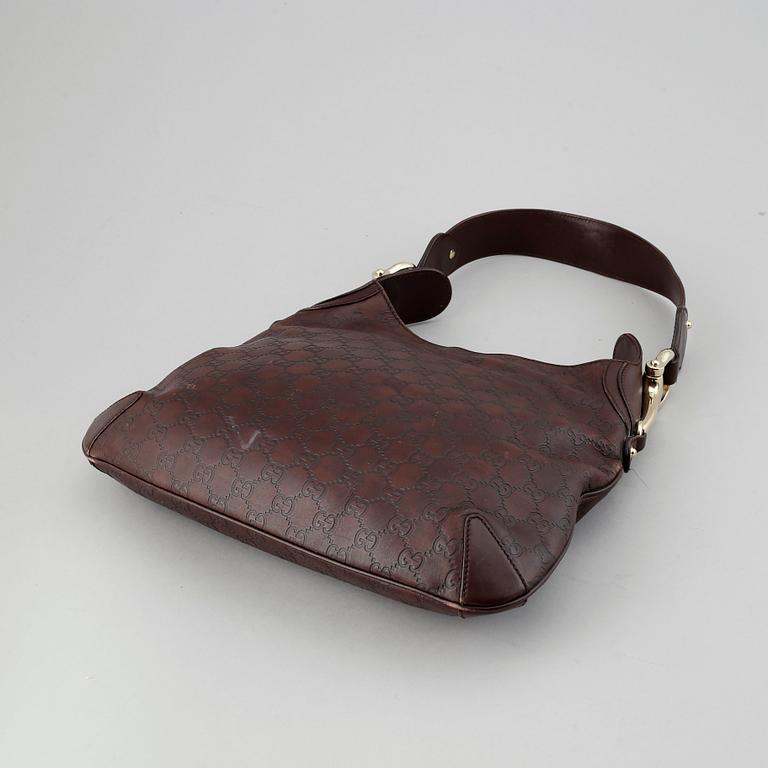 Gucci, a leather bag.
