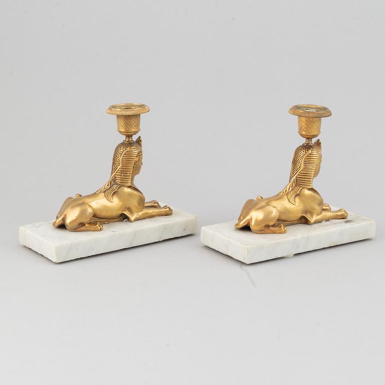 A pair of empire style 19th century candlesticks.