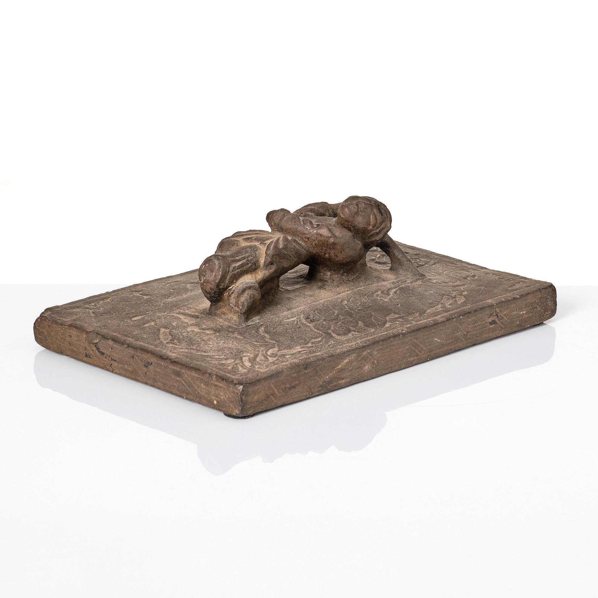 A heavy stone slate/press, presumably Ming dynasty (1368-1644).